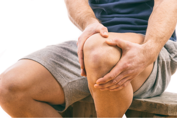 Person holding a sore knee
