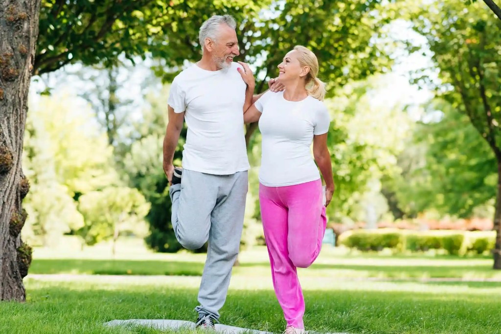 Couple stretching together in a park